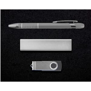 A silver pen, a sleek metal bar, and a silver USB drive arranged on a black background.