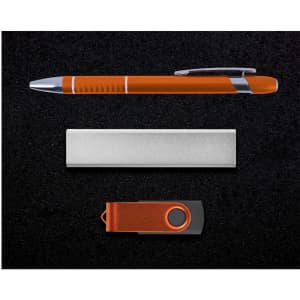 A gift set featuring an orange pen, a silver card holder, and an orange USB flash drive, all on a black background.