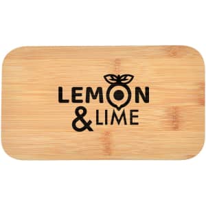 A bamboo cutting board featuring a logo with the words "Lemon & Lime" in black text. The board has a rectangular shape.