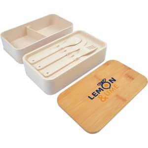 A white lunchbox with a bamboo lid and utensils, featuring a logo. The interior has a divider for compartments.