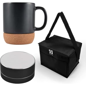 A black coffee mug with a cork base, a black speaker, and a black carrying bag with a strap.