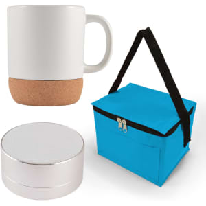 A coffee mug with a cork base, a compact Bluetooth speaker, and a blue insulated carrying bag.