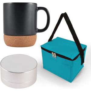A black coffee mug with a cork base, a silver speaker, and a teal carrying bag.