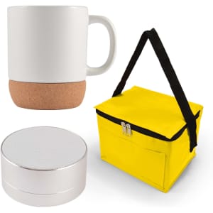 An espresso coffee cup with a cork base, a compact silver speaker, and a yellow insulated carrying bag.