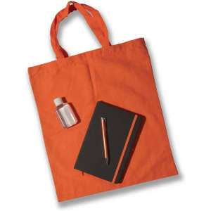 An orange tote bag holds a small clear bottle, a black notebook, and an orange pen.