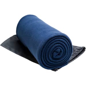 A rolled Polar Blanket in a deep blue color, positioned on a dark gray surface.