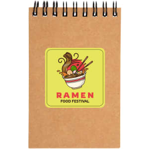 A spiral-bound notebook in brown with a vibrant ramen-themed design on the cover.