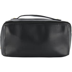 A black tech pack travel bag with a zip closure and a handle on top. It has a smooth, glossy finish.