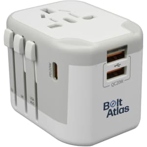 A white travel adapter with multiple plug types and USB ports. It features a logo on one side.