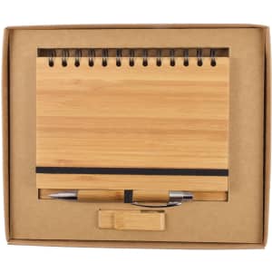 A bamboo notebook and silver pen set displayed in a kraft gift box with a black elastic band.