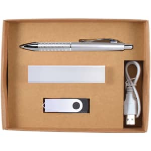 A cardboard gift set containing a silver pen, USB drive, power bank, and charging cable.