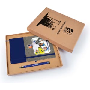 A cardboard gift set featuring a navy notebook, a blue pen, and a card, all in a brown box with a logo.