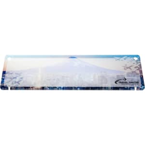 A desk nameplate featuring a scenic design of a mountain and cityscape, along with a logo for a travel center.