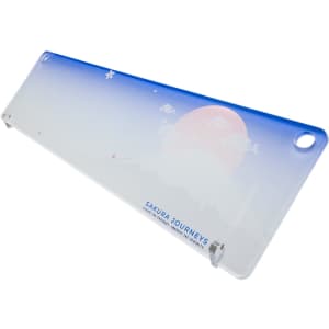 A translucent desk mat featuring a gradient blue and white design with a mountain and sun illustration, plus branding.