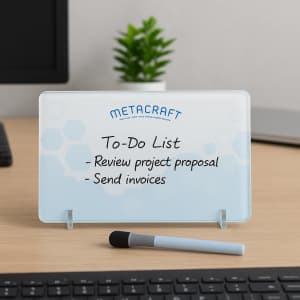 A whiteboard to-do list with a light blue background, a branded logo, and a grey marker on a wooden desk.
