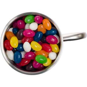 A Java mug filled with assorted mini jelly beans in vibrant colors, including pink, yellow, green, and blue.