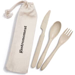 A cutlery set in a calico pouch, featuring a spoon, fork, and knife in a neutral colour. The pouch has a logo.