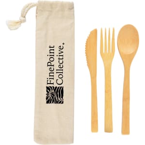 A bamboo cutlery set in a calico pouch, featuring a knife, fork, and spoon. The pouch has a logo.