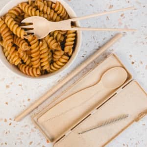 A Ramen Cutlery Set in natural beige, including a fork, spoon, chopsticks, and cleaning brush, in a matching case.