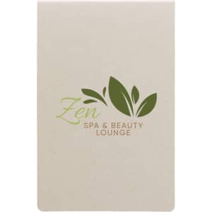 A cream-colored sticky note pad featuring a green logo with leaves and the text "Zen Spa & Beauty Lounge."