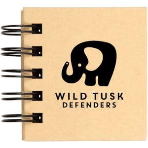 A spiral-bound notebook featuring the logo of "Wild Tusk Defenders," with a graphic of an elephant.