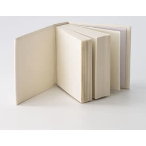 A tower note block featuring multiple stacks of blank pages in a neutral colour, with a simple, unbranded design.
