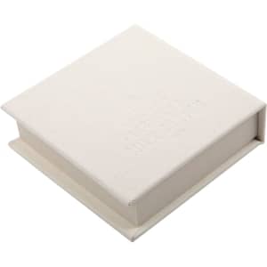 A square, white note block with a textured finish, featuring a logo on the top.
