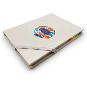 A beige daily planner with a colourful circular logo on the cover and an elastic band. Tabs in various colours are visible.