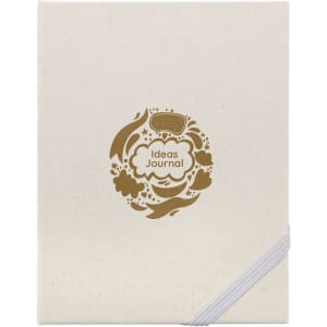 A cream-coloured journal with a gold decorative logo featuring floral designs and the words "Ideas Journal."