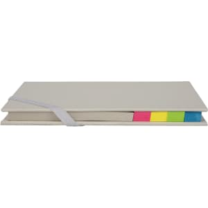 A grey trip daily planner with a secure strap and vibrant sticky tabs in pink, yellow, and green.