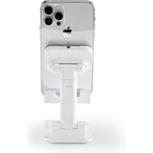 A white phone stand holds a smartphone upright, featuring a sleek design and adjustable features.