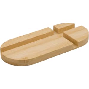 A bamboo phone stand featuring an oval shape with carved slots for stability, showcasing natural wood colour.