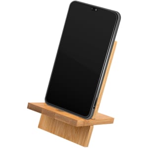 A bamboo phone stand holding a smartphone, showcasing its natural wood finish and minimalist design.