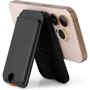 A black phone wallet stands upright against a smartphone, showcasing its sleek design and functionality.