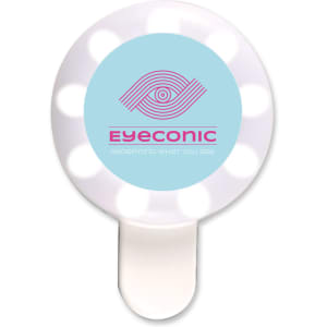 A round, white LED selfie light with a blue centre and a logo. It has multiple bulbs around the edge.