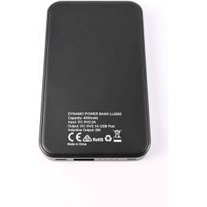 A black Dynamo Wireless Power Bank with specifications printed on the back, including input and output details.