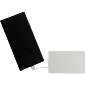 A white power bank is connected to a smartphone, showcasing a sleek design and charging capability.