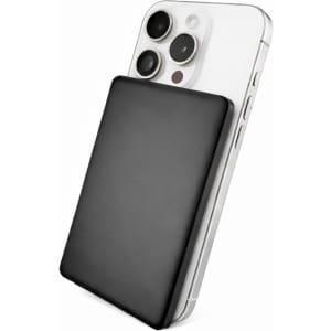 A black solid-state power bank is positioned against a silver smartphone, highlighting its sleek design and portable size.