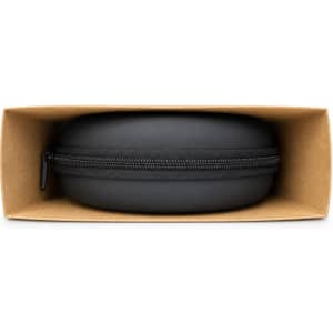 A black circular case for Equinox ANC headphones, displayed inside a rectangular brown box.