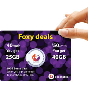 A hand holds a promotional card for Fox mobile plans, featuring a circular phone grip and a purple bokeh background.