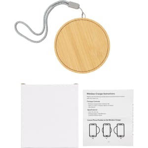 A bamboo wireless charger in a circular shape, accompanied by a plain box and user instructions.