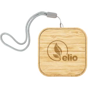 A square wireless charger set made of bamboo, featuring a decorative engraving and a grey strap.