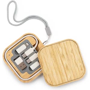 A wooden square charger set in a bamboo case, featuring multiple connectors and a grey strap.