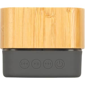 A Bluetooth speaker with a bamboo exterior and a dark gray base featuring control buttons for playback.
