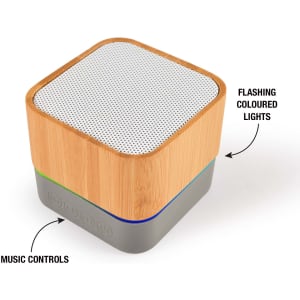 A square Bluetooth speaker with a bamboo exterior, silver mesh top, and colored music control buttons at the base.