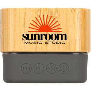 A Bluetooth speaker featuring a bamboo exterior and a grey base, with a logo displayed on the front.
