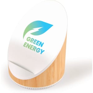 A white and bamboo wireless speaker and charger with a circular design and a logo featuring a leaf and a lightning bolt.