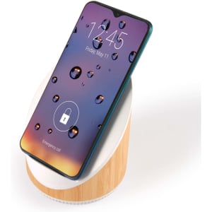 A wireless charger featuring a wooden base and a sleek phone resting on top, displaying a colorful, water droplet screen.