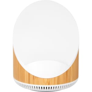 A wireless speaker and charger with a bamboo base and a sleek white top, featuring a minimalistic design.