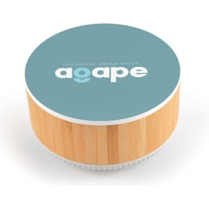 A round speaker with a bamboo base and a blue top featuring a logo and text in white.